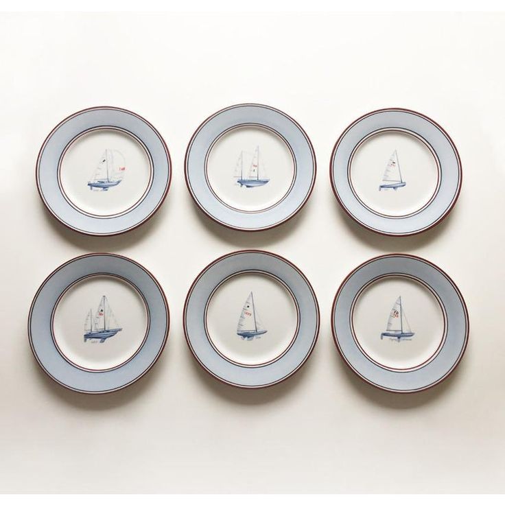 six blue and white plates with sailboats on them are arranged in the shape of a circle