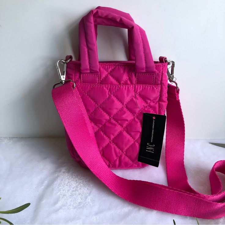 Inc International Concepts Nylon Rachell Quilted Mini Crossbody, Pink, Nwt Color: Orchid (Pink) Material: Body: Polyester; Trim: Pu; Lining: Polyester Hardware: Silver Tone Interior: 2 Interior Slip Pockets & 1 Zip Pocket Exterior: 1 Slip Pocket & 1 Side Zip Pocket Closure: Magnetic Snap Closure Dimensions: Mini Sized Bag Bag: 5.5”W X 7”H X 2”D Removable Crossbody Strap: 25”L Top Handle: 3”L Condition: New With Tag Spring Quilted Nylon Bags, Pink Nylon Mobile Phone Bag, Nylon Shoulder Bag For Spring, Spring Nylon Shoulder Bag, Nylon Mobile Phone Bag, Pink Nylon Bags, Spring Nylon Crossbody Shoulder Bag, Chic Pink Nylon Bag, Mini Crossbody