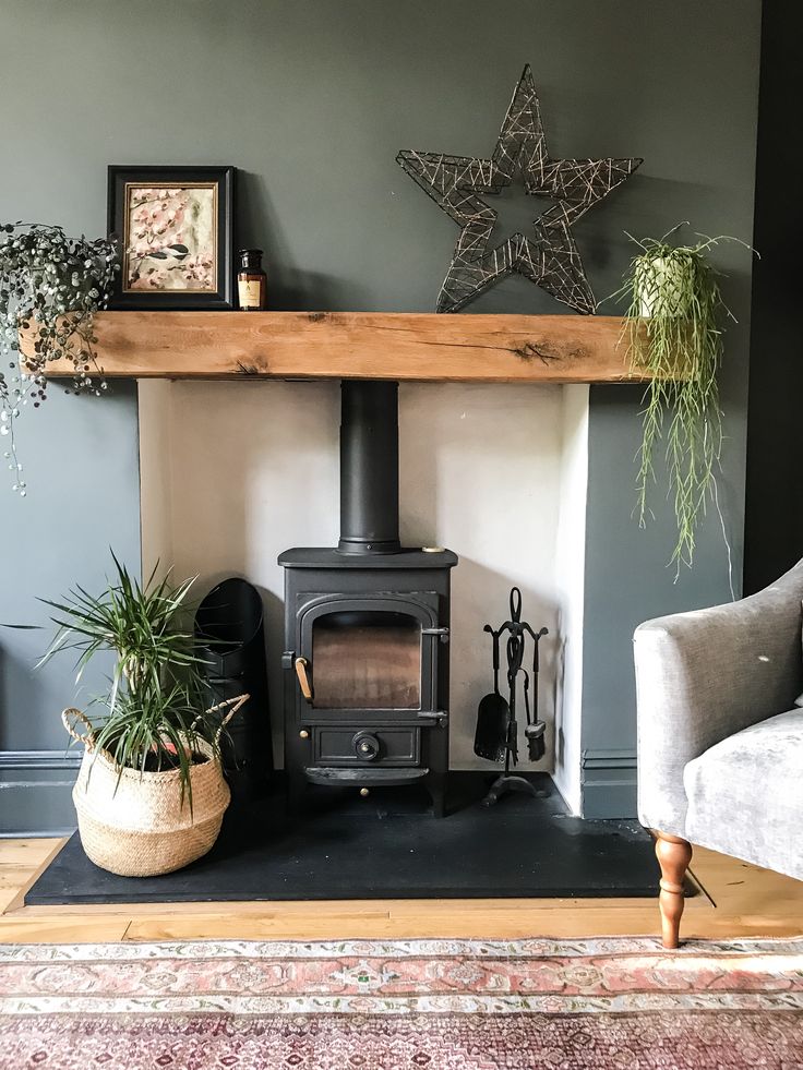 a living room with a fire place and potted plants