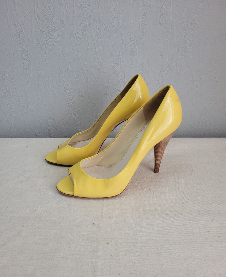 Vintage lemon yellow patent leather high heels women pumps shoes.   Peep toe and stiletto heels. Genuine leather and leather lining. Made in Italy. High quality shoes for elegant everyday look. brand: Miu Miu condition: great used shoes. Has some signs of wear. Looks at the photos. measurements: Heels height 11.5 cm / 4.5" in Outsole length 26.5 cm / 10.3" in bottom sole width in widest place 8 cm / 3.1" in  SIZE: EU 39.5 - labeled size US 8 Yellow Patent Leather Heels For Spring, Spring Almond Toe Patent Leather Heels, Yellow Open Toe Heels With Sculpted Heel, Elegant Yellow Patent Leather Heels, Modern Yellow Open Toe Heels, Yellow Patent Leather Heels For Formal Occasions, Yellow Patent Leather Party Heels, Chic Yellow Patent Leather Heels, Yellow Patent Leather Heels For Evening