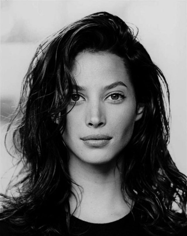 a black and white photo of a woman with long hair