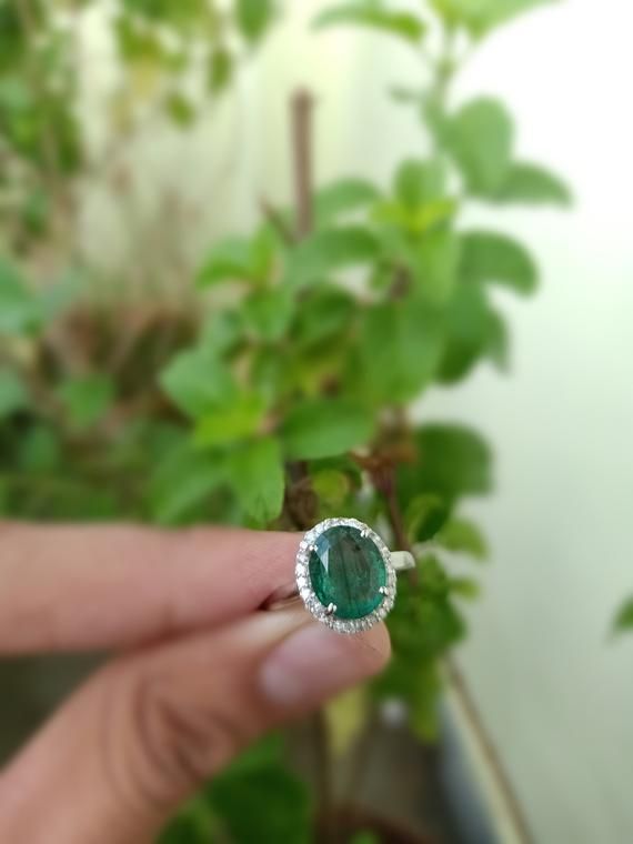 Oval natural emerald and diamond engagement ring for womens and girls in 14k solid gold / best surprised gift for womens and girls  / on this christmas surprised your love with this beautifull raw emerald ring ......../ best gift for may birthstone lover .--------------------------------------------------------------------Item description - stone - natural emeraldshape - ovalsize - 9.20 mm width and 10.90 mm lengthcolour - rich green lusterorgin - zambianmaterial - 14k and 18k solid gold ( hall Green 14k Gold Halo Ring As A Gift, Gift Halo Ring With Emerald Cut, Dazzling Diamond Emerald Ring, Emerald Cut Halo Ring Gift, Diamond Emerald Ring With Halo Design As Gift, Diamond Emerald Ring With Halo Design For Gifts, Exquisite Rings With Halo Setting As Gift, Fine Jewelry Gemstone Halo Ring Gift, Dazzling Diamond Emerald Ring As Gift