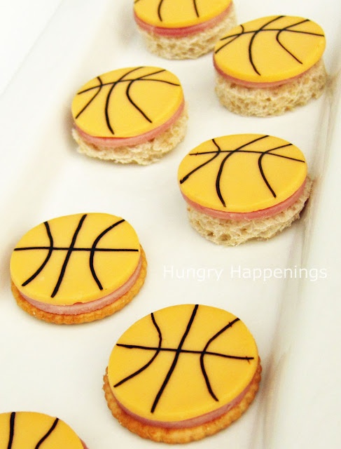 cookies decorated with basketballs are sitting on a white tray and ready to be eaten