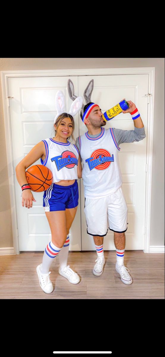 a man and woman dressed up as rabbits with basketballs on their heads, standing next to each other