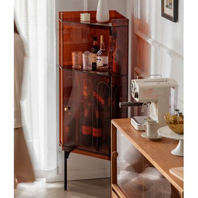 a brown cabinet with wine bottles on it and a sewing machine in front of it