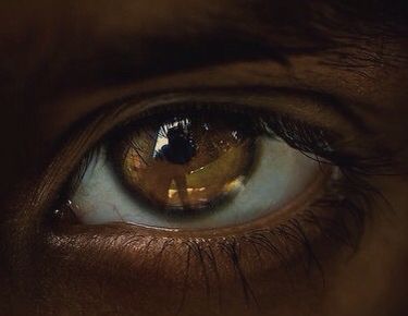 an extreme close up shot of a person's eye with the reflection in it