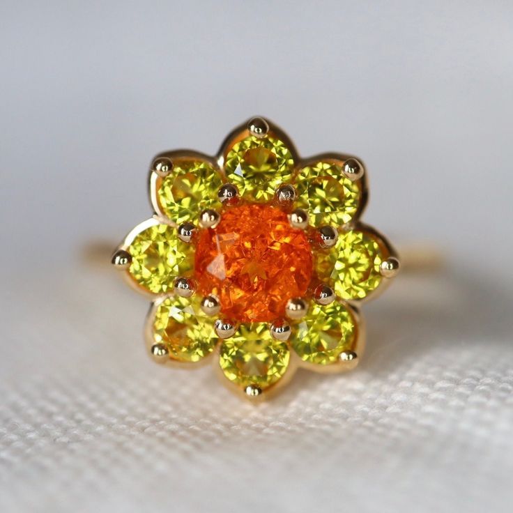 Neon Orange Fanta Garnet Yellow Sapphire Daisy Ring Orange Spessartite Garnet and Daisy Sapphire Cluster Ring Mandarine Garnet Made to Order Condition: Brand New & Custom Designed by me Size: Customizable  Metal: Solid 14K Yellow Gold Center Stone: Neon Orange Garnet Side Stones: Natural Yellow Sapphires 1.2ct Measurement: 15mm*15mm Certificate Included. 7-day return accepted. This item will be sent in well-made velvet jewelry box Please feel free to browse my shop for hundreds of additional pie Mandarin Garnet Ring, Sapphire Cluster Ring, Sapphire Halo Ring, Spinel Jewelry, Pretty Accessories, Spessartite Garnet, Woman Jewelry, Daisy Ring, Velvet Jewelry