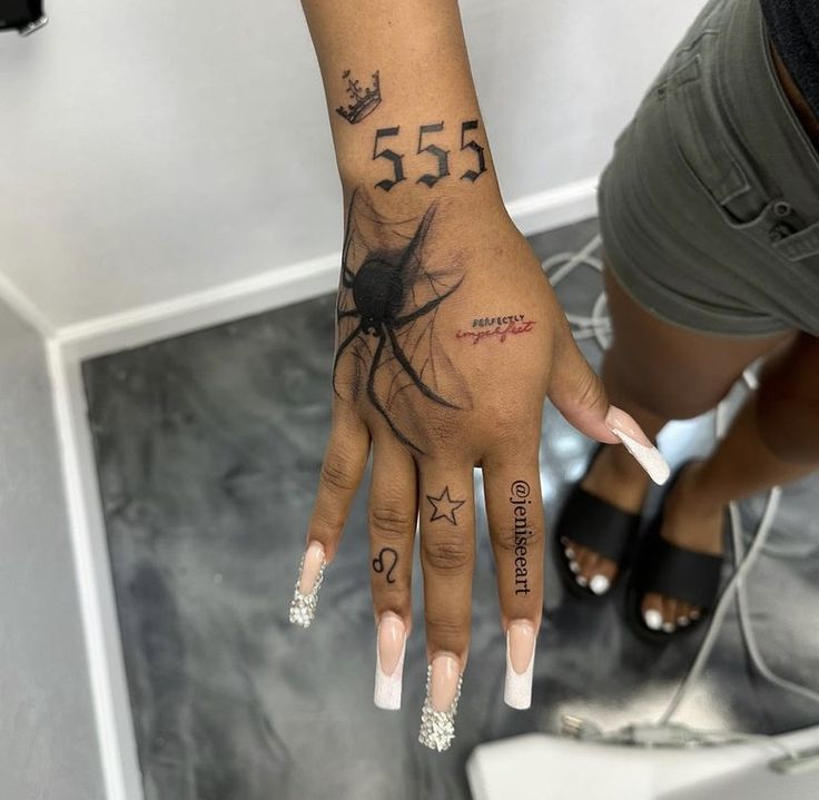 a woman's hand with tattoos and numbers on it