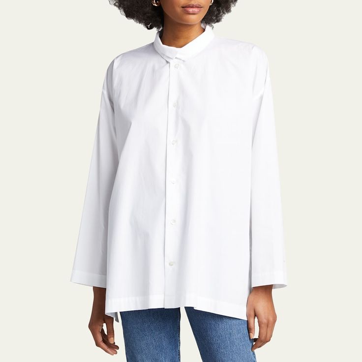 Eskandar blouse in cotton poplin Stand collar with spread collar overlay; button front Dropped shoulders Long, wide sleeves Step hem 100% cotton Made in Poland of Italian materials Modern Fall Shirt For Daywear, Daywear Poplin Blouse With Button Cuffs, Relaxed Fit Long Sleeve Poplin Blouse, Oversized Classic Poplin Blouse, Classic Oversized Poplin Blouse, Classic Poplin Blouse For Daywear, Fall Poplin Shirt, Poplin Tops With Spread Collar For Daywear, Poplin Top With Spread Collar For Daywear