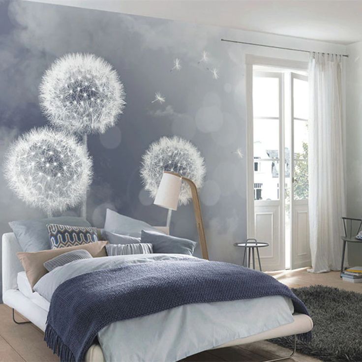 a bedroom with dandelions painted on the wall