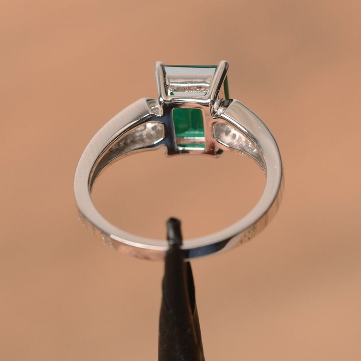 It is a lab emerald ring. The main stone is 7 mm*9 mm emerald cut.weight about 2.06 carats. The basic metal is sterling silver and plated with rhodium. To change the metal to a solid gold (white/rose) or platinum is also available, please ask for a quotation if you want. You can also go to my shop Home for more elegant rings: https://www.etsy.com/shop/godjewelry?ref=hdr_shop_menu Emerald is May birthstone More emerald rings: https://www.etsy.com/shop/godjewelry?ref=seller-platform-mcnav&sect Silver Emerald Cut Anniversary Emerald Ring, Fine Jewelry Emerald Cut Ring For May Birthstone, Fine Jewelry Square Cut Emerald Ring For Anniversary, Fine Jewelry White Gold Emerald Cut Birthstone Ring, Emerald Cut Emerald Ring In White Gold For Anniversary, Fine Jewelry White Gold Birthstone Ring Emerald Cut, White Gold Emerald Cut Emerald Ring For Anniversary, White Gold Emerald Cut Birthstone Ring, Green Emerald Cut Birthstone Ring