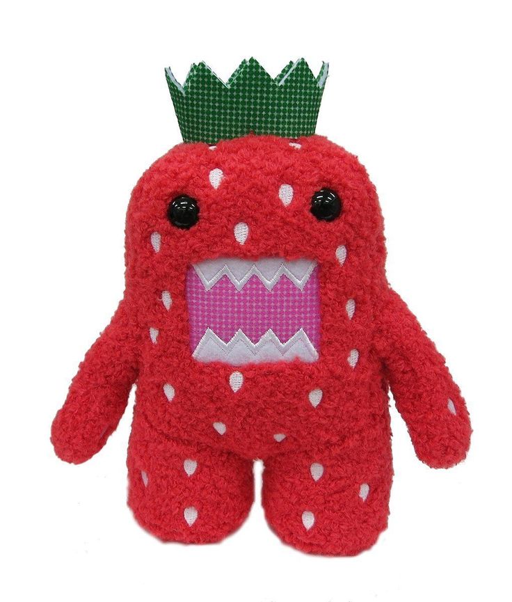 a red stuffed animal with a green crown on top of it's head and mouth