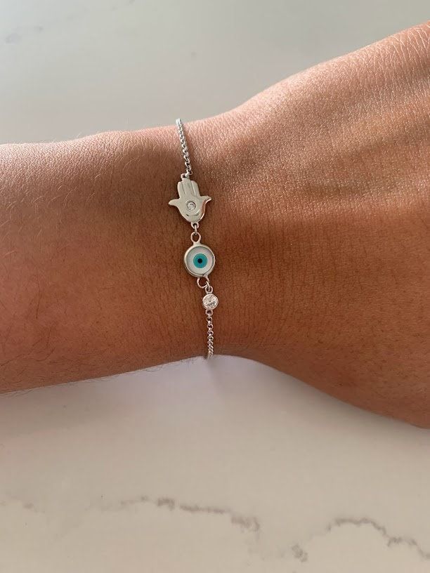 Evil Eye Hamsa Bracelet in Sterling Silver, Evil Eye, Hamsa, Bracelet, Guardian Angel Bracelet, Sterling Silver Bracelet, Hamsa Bracelet ----------------------------------------------- ♦ ------------------------------------------------- Great bracelet for everyday wear. It is rhodium over silver, a strong material to help your jewelry looking great for a long period of time - wear it in the shower and it won't tarnish. The Silver Eye Bracelet with Cross comes at a great affordable price and make White Adjustable Chain Bangle Bracelet, Adjustable White Chain Bangle Bracelet, Adjustable Symbolic Beaded Bracelets, Adjustable Hypoallergenic Silver Evil Eye Bracelet, White Sterling Silver Friendship Bracelets, White Sterling Silver Bohemian Bracelets, White Bohemian Bracelet With Adjustable Chain, Handmade Adjustable White Chain Bracelet, Bohemian White Sterling Silver Bracelets