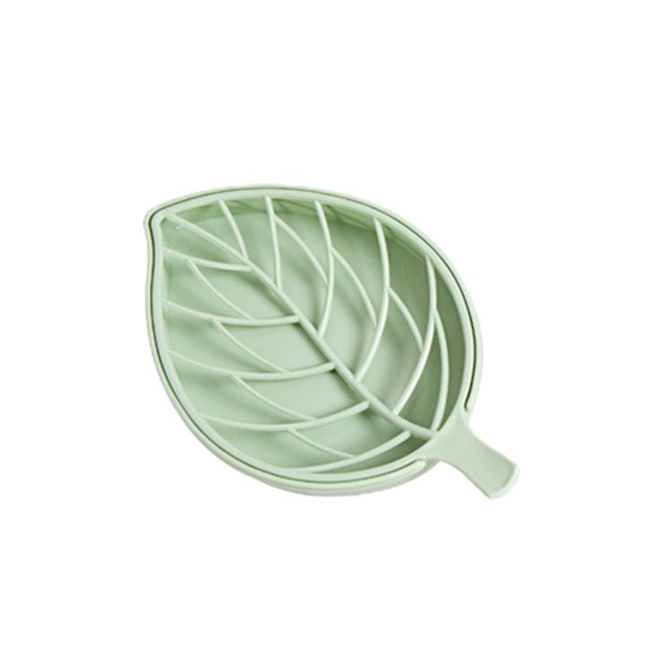 a green leaf shaped bowl on a white background, with the bottom section cut out