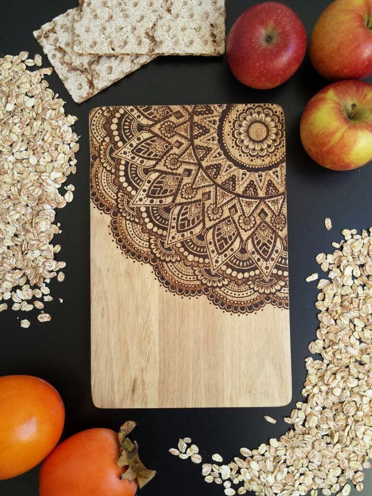 an apple, oatmeal and some apples on a table with a cutting board