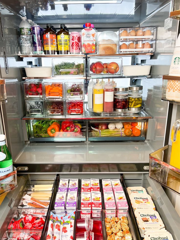 an open refrigerator filled with lots of food and condiments in it's shelves