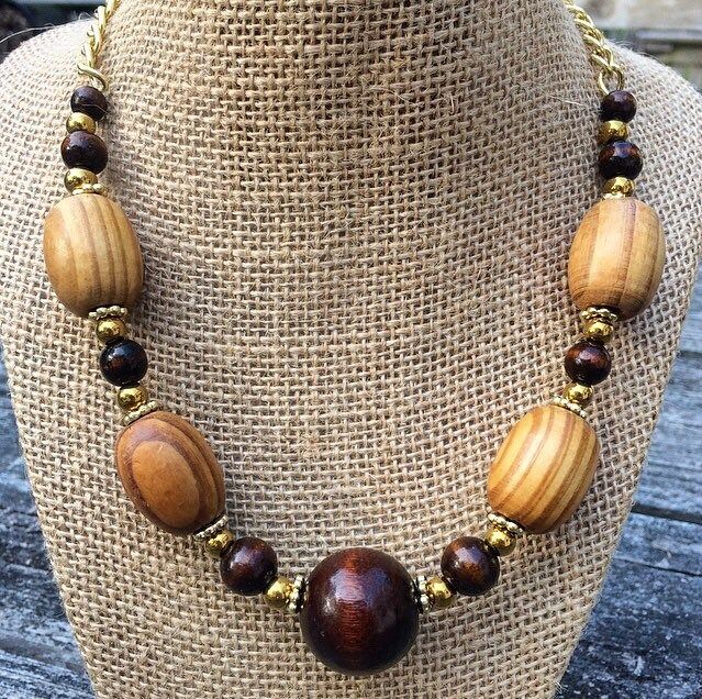 This elegant, one of a kind necklace is made up of real wood- stained light and dark - and painted gold beads. The beads are all tied securely to a gold chain which fastens easily behind the neck with a toggle clasp. The necklace measures around 18 inches long. Wood Beads Necklace Ideas, Adjustable Brown Wooden Necklaces, Natural Wood Necklaces With Wooden Beads For Gift, Adjustable Gold Beaded Necklaces With Wooden Beads, Adjustable Gold Beaded Necklace With Wooden Beads, Gift Wooden Bead Necklaces In Natural Wood, Gold Beaded Necklaces With Wooden Beads, Adjustable Gold Necklace With Wooden Beads, Gold Beaded Necklace With Wooden Beads