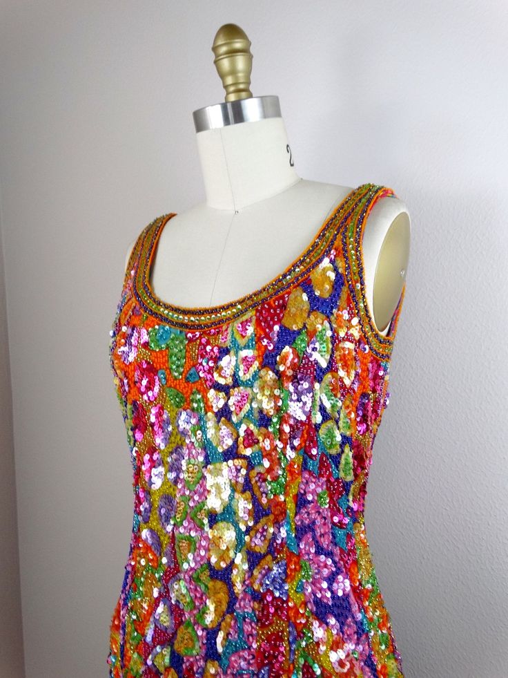 "This vintage beauty is by Oleg Cassini's Black Tie and it's fully embellished with bright sequins and beads in a funky, abstract design! It's in perfect condition! Measurements: Bust - 32/34\" Waist - 26/28\" Hips - 35/37\" Total Length - 35\" Tag Size - 4 All of my items come from a smoke-free and pet-free home. If you would like more info or have any questions, please don't hesitate to ask!" Fitted Sequin Dress For Festival, Multicolor Sequin Fabric For Disco In Summer, Fitted Sleeveless Sequin Dress For Festivals, Multicolor Hand Embellished Party Dress, Hand Embellished Multicolor Party Dresses, Festive Multicolor Embellished Dress, Summer Sequin Embellished Dress For Costume Party, Glamorous Multicolor Sequin Dress For Festive Occasion, Multicolor Festival Dress For Party Season