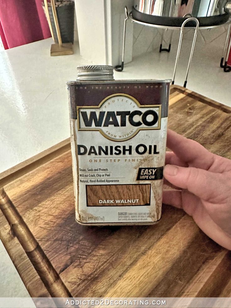 a can of watch danish oil sitting on top of a wooden table in a kitchen