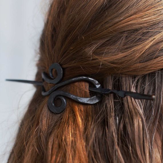 a woman with long hair has scissors in it's back end and is seen from the side