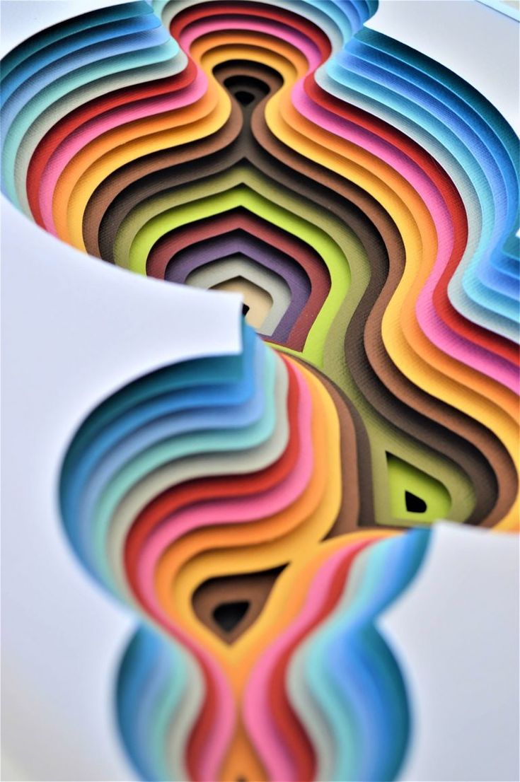 multicolored spirals are arranged in the shape of an abstract figure on a white background