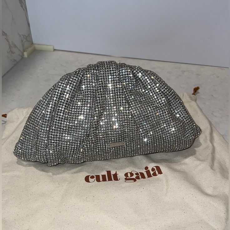 Brand New No Defects ( Check The Pics) Mini Jaala Rhinestone Clutch Bag Silver Tone Logo Plaque Magnetic Fastening Never Been Used, No Defects ( Check The Pictures) Trim: Sheep Leather Lining: Polyester Comes With A Protective Dust Bag & Extra Crystal Just In Case You Need It Luxury Silver Clutch Bag, Silver Rhinestone Pouch Bag, Luxury Silver Pouch Bag, Designer Silver Clutch Bag, Luxury Silver-tone Pouch Evening Bag, Silver Evening Bag With Dust Bag For Party, Luxury Pouch Clutch With Silver-tone Hardware, Silver Clutch Bag With Bling, Silver Bags With Silver-tone Hardware For Events