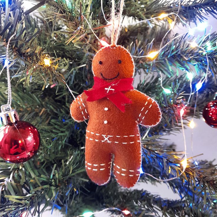 a teddy bear ornament hanging from a christmas tree