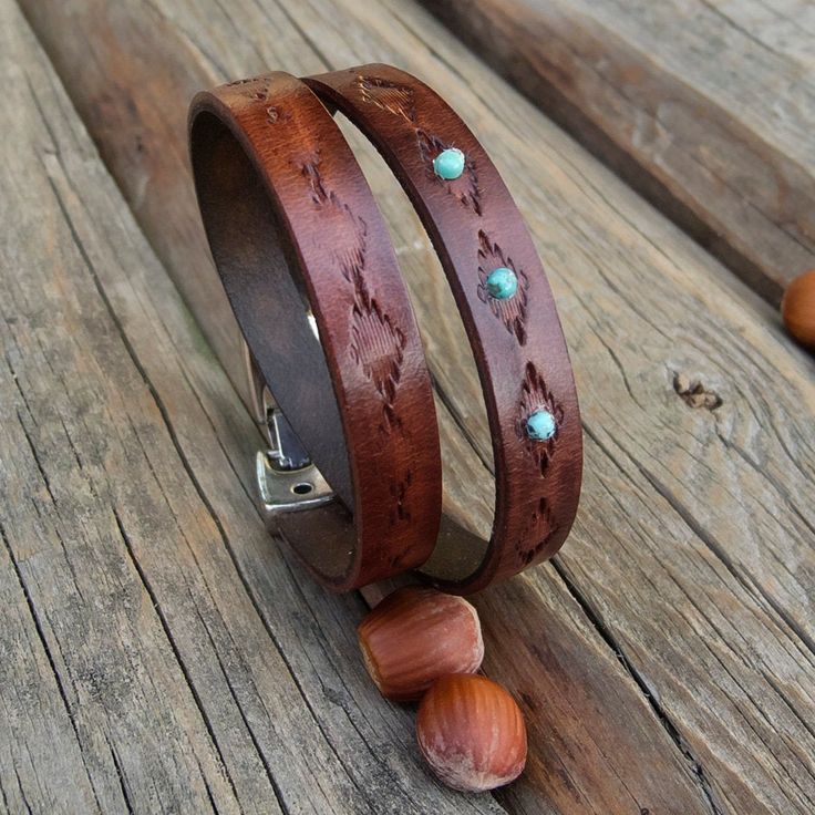 "Made from top quality vegetable tanned leather. Hand painted and stamped leather wrap around bracelet. It is embellished with natural Tibetan Turquoise cabochons. Bangle is 1 cm wide and with zamak clasp closure. Please measure carefully your wrist and select the most preferable size! If you need a diferent size, please let me know after purchase in \"note for seller\". Please visit to my another shop: https://www.etsy.com/shop/JeansBelt?ref=hdr_shop_menu FEDEX to USA and Australia! If you need Rustic Brown Bracelet With Concho, Rustic Brown Concho Bracelets, Southwestern Hand-tooled Brown Bracelets, Rustic Leather Concho Bracelets, Rustic Hand Tooled Leather Bracelets, Handmade Southwestern Brown Leather Bracelet, Southwestern Hand Tooled Leather Bracelets, Western Style Hand Tooled Leather Bracelets, Western Leather Bracelet As A Gift