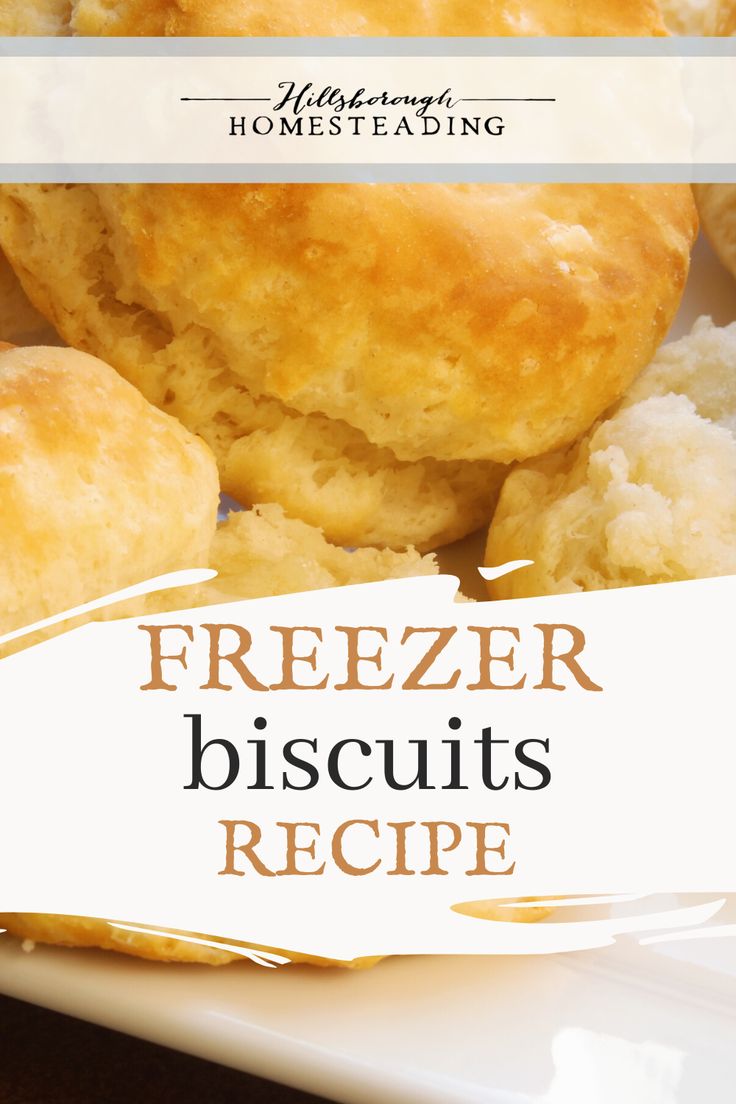 a white plate topped with biscuits covered in frosting next to a sign that says freezer biscuits recipe