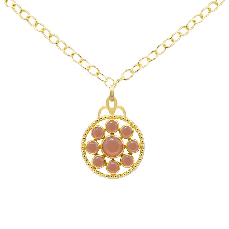 This 18k gold plated medallion necklace features a stunning gemstone design, adding a touch of sophistication and elegance. The necklace measures 17 to 18 inches, allowing for a versatile fit. Available in Tanzanite, Green Onyx, Blue Sapphire, and Peach Moonstone, each option brings its own unique hue and character. Pair this necklace with the Florentina Earrings, Giselle Stud Earrings, and Arden Ring for a coordinated and polished look. Medallion Necklace, Peach Moonstone, Green Onyx, Blue Sapphire, Moonstone, Onyx, 18k Gold, Sapphire, Gold Plate