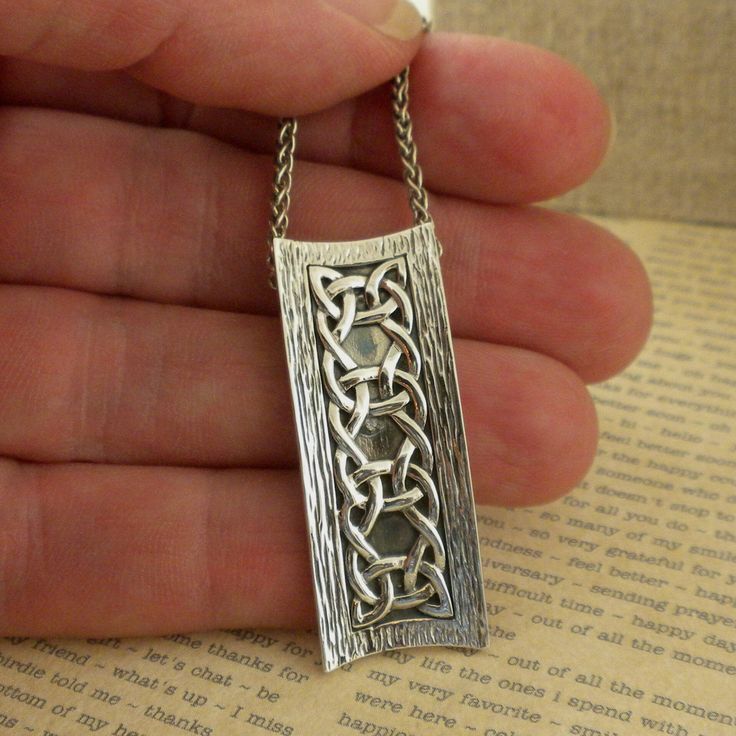 "Celtic Scavaig Pendant by Keith Jack Sterling Silver Celtic Weave design Oxidized background with bark edges 1.5\" long and 1/2\" wide, stamped .925 18\" sterling silver chain. Nicely boxed with silver cloth. Scavaig Pendant by Keith Jack Jewelry Imported from Canada Signed by the Artist In Stock! Ships Immediately. Ships Free within the USA 21 Day Returns Items must be returned in new unworn condition." Artisan Sterling Silver Rectangular Necklace, Artisan Silver Necklace With Rectangular Pendant, Hand Forged Silver Rectangular Pendant Necklace, Hand Forged Sterling Silver Necklace With Rectangular Pendant, Oxidized Rectangular Pendant Necklace For Gifts, Oxidized Finish Rectangular Pendant Necklace As Gift, Oxidized Finish Necklaces With Rectangular Pendant For Gift, Hand Forged Square Pendant In Sterling Silver, Hand Forged Sterling Silver Jewelry Gift