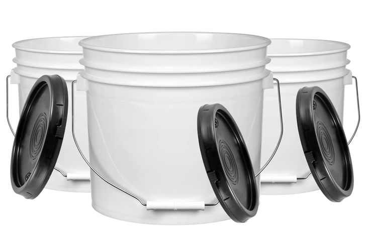 three white buckets with black lids on them