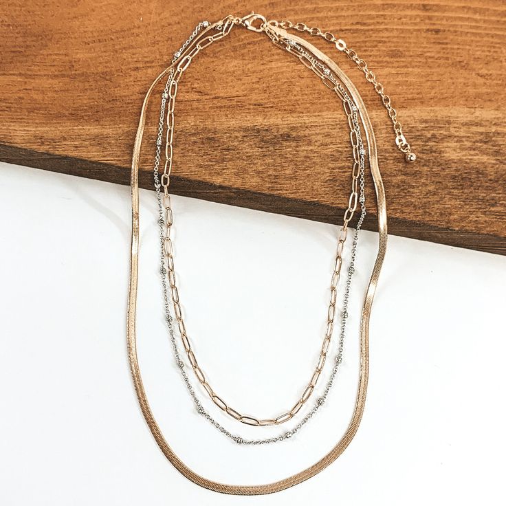 This tiny chained necklace are perfect for layering! Pair with other gold jewelry or mixed metal pieces! This necklace is adjustable up to 18 inches long. SKU: #1102-2132 Dainty Silver Snake Chain Necklace With Adjustable Chain, Delicate Metal Link Layered Necklace, Metal Chain Necklace With Adjustable Chain For Layering, Adjustable Metal Chain Necklace For Layering, Silver Charm Necklaces With Gold Chain In Dainty Style, Metal Adjustable Chain Necklace For Layering, Silver Double Strand Delicate Chain Necklace, Dainty Satellite Chain Metal Necklace, Dainty Metal Satellite Chain Necklace