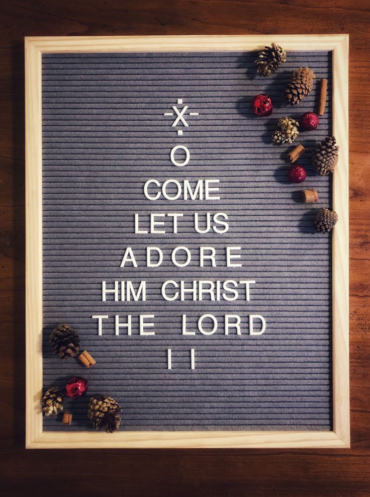 a framed sign with pine cones and acorns on it that says, come let us adore him christ the lord 11