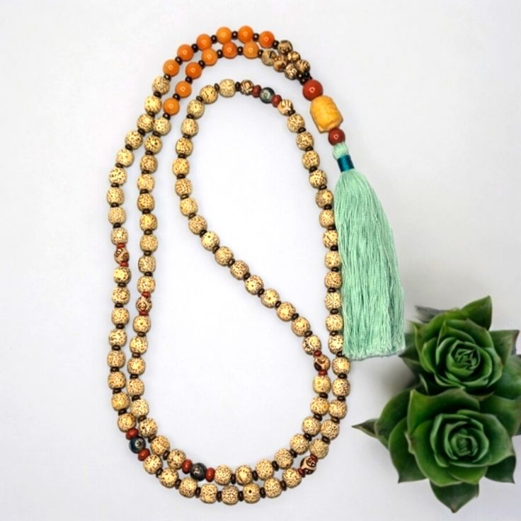 - Handcrafted Bodhi Seed | Tibetan Agate With Bronzite 8mm Gemstone Mala Necklace The Mala Is Made With 108 (8mm) Gemstone Beads. The Length Is Approximately 51.5" And Includes The Tassel. The Beads Are Bodhi Seed. The Spacer Beads In-Between The Bodhi Seeds Bronzite And The Sectional Spacer Beads Are Red Jasper & Teal Blue Tibetan Agate Gemstone Beads. The Guru Bead Is A Suzhou (Pronounced, "Soochow") Jade Carved Buddha Head With An 10mm Red Jasper Bead On The Top And An 8mm Red Jasper Gemstone Gold Healing Mala With 108 Beads, Gold Mala With 108 Beads For Healing, Adjustable Orange Jewelry With 108 Beads, Gold Spiritual Mala For Healing, Adjustable Gold Mala With 8mm Beads, Yellow Beaded Jewelry For Meditation, Amber Beaded Necklace For Meditation, Spiritual Yellow Necklaces For Meditation, Gold Bohemian Mala As Gift