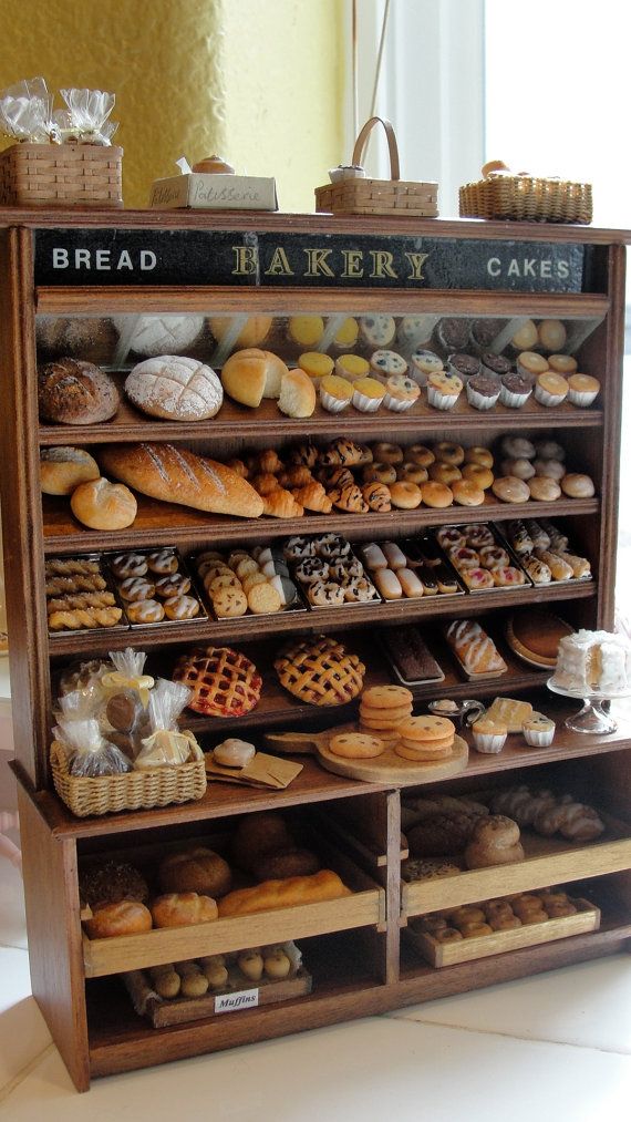 a bakery display case filled with lots of different types of breads and pastries