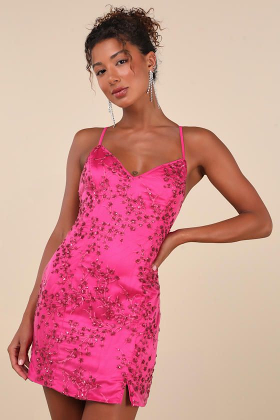 Slip into the Lulus Blissful Blossoms Fuchsia Pink Sequin Backless Mini Dress for your next elegant affair! Clusters of sparkly sequins and intricate embroidery create a floral blossom pattern across mesh fabric as it shapes a V-neckline and princess-seamed bodice, supported by adjustable spaghetti straps that crisscross atop an open back. A figure-skimming silhouette falls to a flirty mini skirt with a notched detail along the hem. Hidden back zipper/clasp. Fit: This garment fits true to size. Pink V-neck Mini Dress For Prom, Pink Satin Backless Mini Dress, Pink V-neck Mini Dress With Sequins, Sparkling Sequin Dress For Prom In Spring, Sparkling Sequin Dress For Spring Prom, Spring Prom Sequin Dress With Sparkling Details, Pink Sequin Dress For Prom, Pink Sequin Dress For Night Out And Holiday, Pink Satin Mini Dress For Party Season