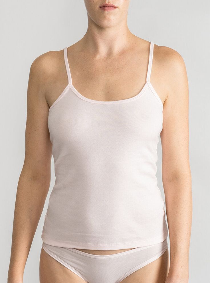 Lightweight layer in breathable organic cotton A wardrobe essential that’s perfect on its own or layered with a sweater. The camisole’s sweetly scooped neckline and slender spaghetti straps flatter décolletage and add understated elegance to the everyday. Made in North Carolina using 100% USA-grown organic cotton— the best and softest around. Wear your Lake Jane bralette under for a cool layered look! Because of the high quality of this organic fabric, you’ll get tons of wear out of your cami wi Feminine Tank Top With Built-in Bra, Feminine Tank Top With Spaghetti Straps And Built-in Bra, Daywear Camisole With Built-in Bra And Scoop Neck, Feminine Bra-friendly Tank Top, Spring Cotton Camisole With Wide Straps, Scoop Neck Camisole For Spring Loungewear, Spring Loungewear Camisole With Scoop Neck, Spring Scoop Neck Camisole For Loungewear, Feminine Bra-friendly Camisole Top