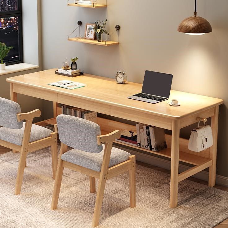 a desk with two chairs and a laptop on it