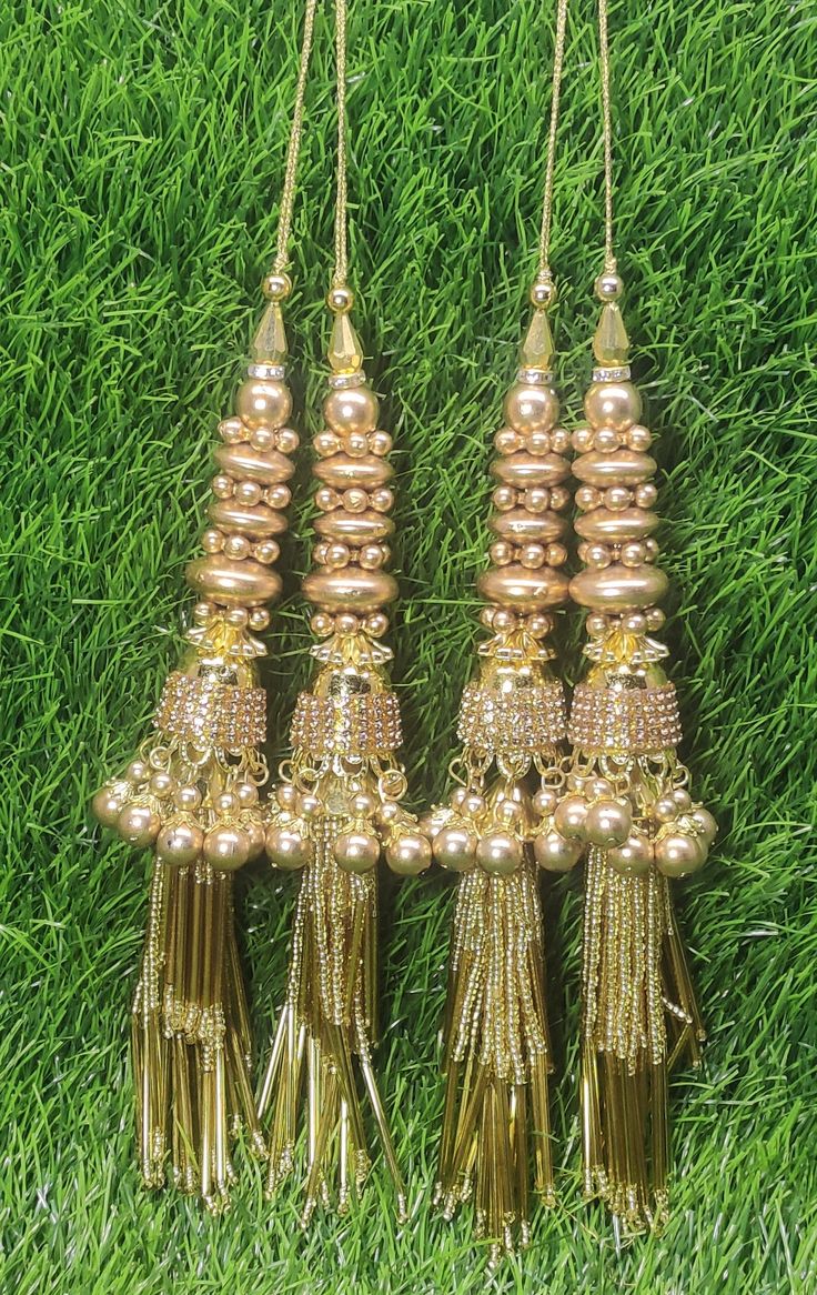 Indian Handmade Golden Latkan for Saree Blouse Lehenga HandBags Hangings Dupatta Decoration Bridal Wedding dress for Women pair of 2 pcs Size - 18.00 cm Length  Item Description You can use this Beautiful pair of tassle for several DIY projects.  *These beautiful Tassel Latkans are used as the accessory for saree blouse on the back, but u can use according to your need and your innovative ideas. * Package contains 2 Latkan / 1 Pair Other Than Saree Blouse, you can use these latkans in various ways Craft Projects Designing Home Decoration Festive celebrations. Evening and party Apparels. Home décor items Apparel & Fashion Scarves n Stoles Headband, hats Table cover, curtains, Pillow covers, Cushion cover Shoe designing Headband, hats Table cover, curtains Designing stylish blouses Ship From Fabric Latkan For Dupatta, Cheap Wedding Chandelier Earrings With Latkans, Latkan Tassels Blouses Accessories, Traditional Luxury Chandbalis With Latkans, Luxury Latkans Danglers, Luxury Chandbalis With Latkans For Wedding, Cheap Wedding Chandbalis With Latkans, Cheap Jewelry With Latkans For Diwali, Diwali Party Sets With Latkans