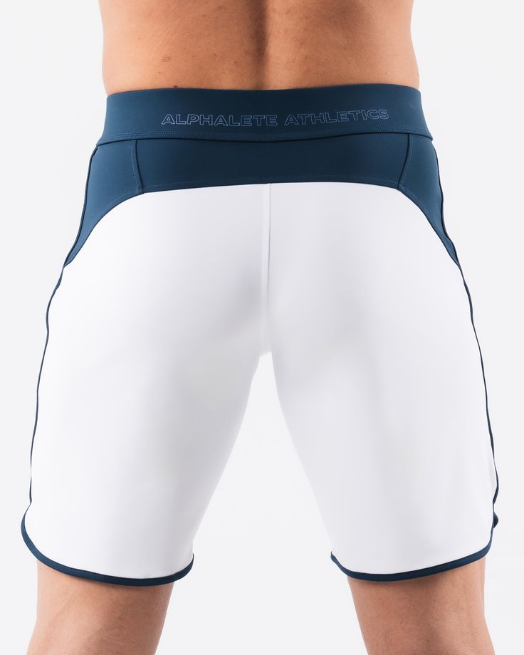 HIGHLIGHTS.. Unlined boardshort. 9” inseam Reflective branding at leg opening and back waistband Elastic waistband with adjustable self-tie drawcords Color-blocking panelling Water resistant fabric FIT SUGGESTION. This item runs true to Alphalete’s standard sizing.. Fit is based off of waist size in inches.. If you are between sizes, we recommend sizing up for a relaxed fit.. Eric is 6’2”/188cm, wearing a size 32. MATERIALS AND WASHING DIRECTIONS. 67% Nylon, 23% spandex. Due to the high saturati White Nylon Athletic Shorts With Built-in Shorts, Functional White Athletic Shorts With Built-in Liner, White Swim Trunks With Built-in Shorts, Compression Training Bottoms With Waistband, Athleisure Swimwear With Functional Drawstring For Workout, White Functional Nylon Athletic Shorts, White Nylon Workout Bottoms, White Functional Nylon Shorts, Functional White Nylon Shorts