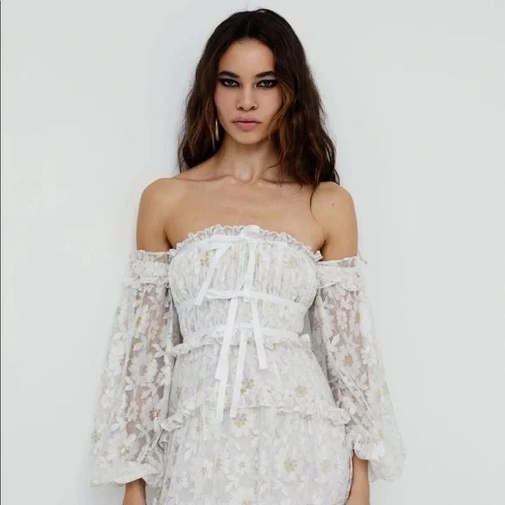 For Love & Lemons Lace Dress Size: S New With Tag Original: $398 50 Shades Of Summer. Dreamy And Flowing Lurex Daisy Lace Off- The-Shoulder Dress Featuring Decorative Bows, A Hi-Low Tiered Skirt, And Billowing Sleeves. Invisible Zipper At Back, Partially Lined. Fabric Composition: 90.1 % Nylon/9.9% Metallic Fiber; Contrast: 86% Viscose/14% Metallic; Lining: 98% Recycled Polyester/2% Spandex Please Note, Lowball Offers Will Not Be Accepted White Off-shoulder Mini Dress For Brunch, Off-shoulder Lace Dress For Spring Wedding, Off-shoulder Lace Wedding Dress For Spring, Spring Wedding Off-shoulder Lace Dress, White Off-shoulder Mini Dress For Daywear, White Off-shoulder Lace Dress, Off-shoulder White Midi Dress For Wedding, White Off-shoulder Midi Dress For Wedding, White Off-shoulder Feminine Dress