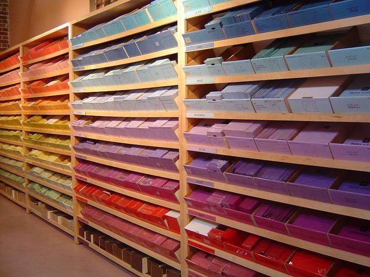 the shelves are filled with many different colored boxes