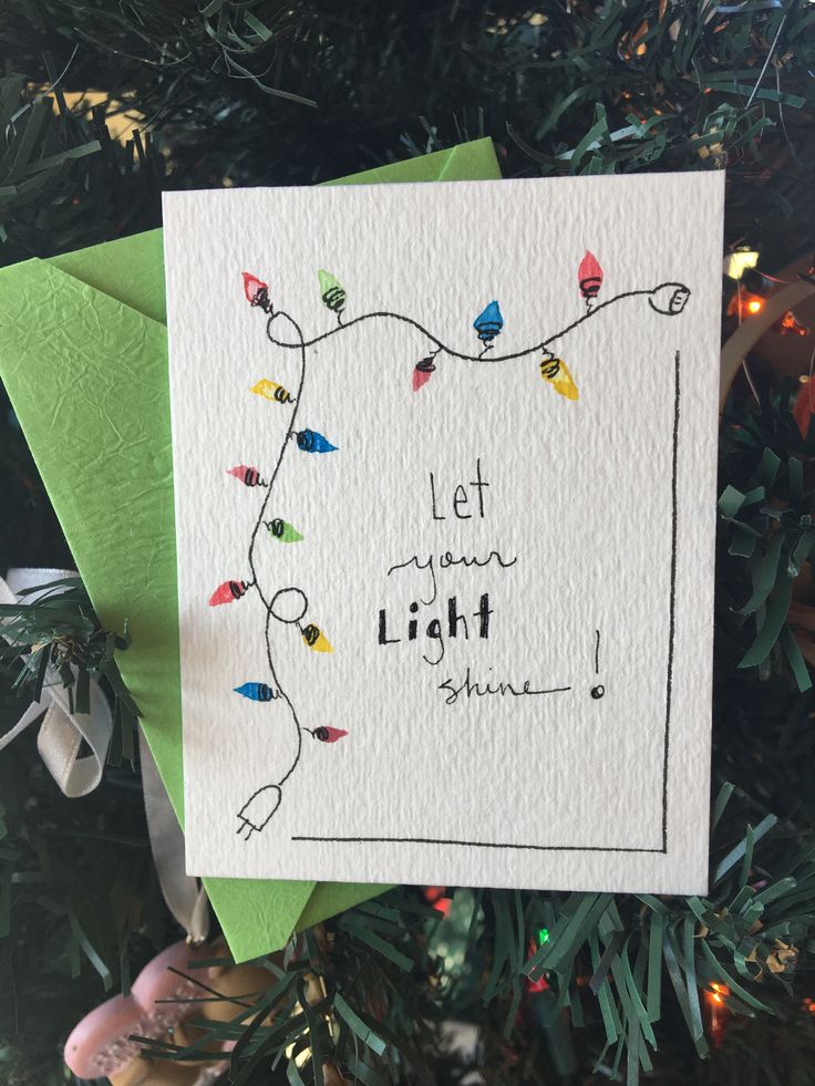 an ornament hanging from a christmas tree with the words let your light shine