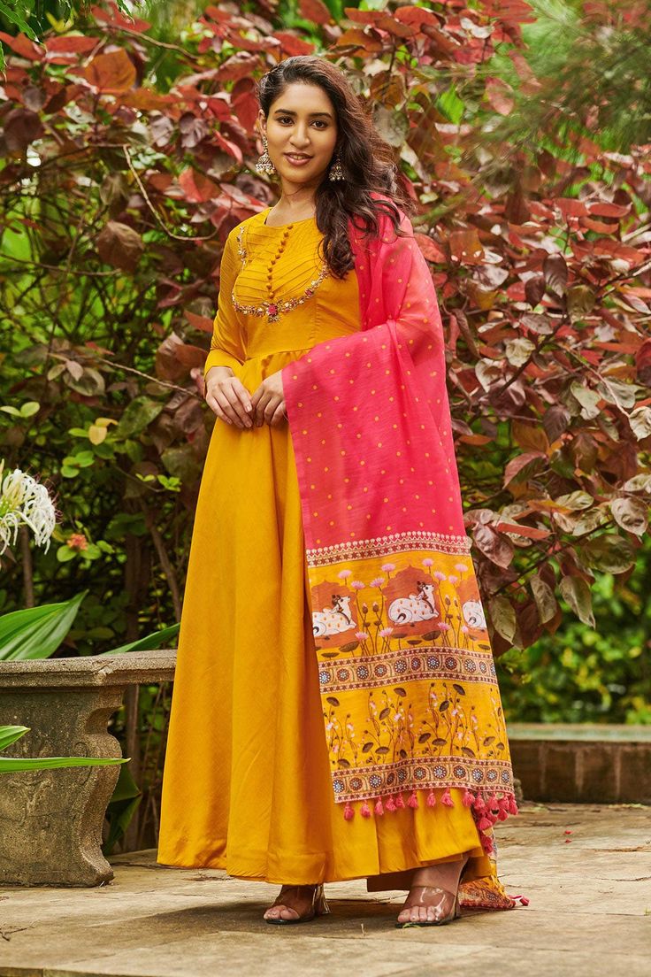 Umbre Pichwai Suit Set, where elegance meets a touch of enigma! The classic Yellow hue gets a playful upgrade with the pichwai pattern, which is as captivating as a starlit night. The handwork adds a sprinkle of glamour, while the linen dupatta floats like a whisper of intrigue, completing the look. (Side zip attached)Size small 36Dress Fabric- Honey silkDress Length- 52inch Yellow Slub Silk Salwar Kameez With Dori Work, Yellow Slub Silk Bollywood Set, Yellow Slub Silk Traditional Wear With Gota Work, Unstitched Yellow Slub Silk Sharara, Yellow Slub Silk Dupatta With Dabka Work, Traditional Yellow Slub Silk Anarkali Set, Yellow Slub Silk Churidar For Festivals, Diwali Maxi Length Kurta With Gota Work, Maxi Length Salwar Kameez With Gota Work In Chanderi