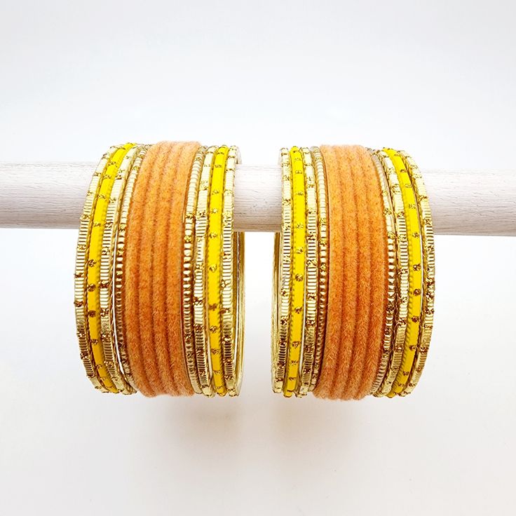 Beautifully designed bangles for any occasion. South asian bracelets come in a variety of styles, colors, and finishes. We at Banglez take creating the perfect bangle set for you to another level! You could say helping you find your favorite stack of bangles as one of our greatest missions. This bangle set was curated in house by one of our talented team members. We hope you love them as much as we do! Festive Yellow Bangle Jewelry, Bohemian Orange Bangle Jewelry, Orange Bohemian Bangle Jewelry, Handmade Yellow Bangle Jewelry, Traditional Stackable Bangle Cuff Bracelet, Adjustable Yellow Bangle For Gift, Adjustable Round Cuff Bracelet For Festive Occasion, Adjustable Yellow Bangle For Festivals, Stackable Bangle Jewelry For Festivals