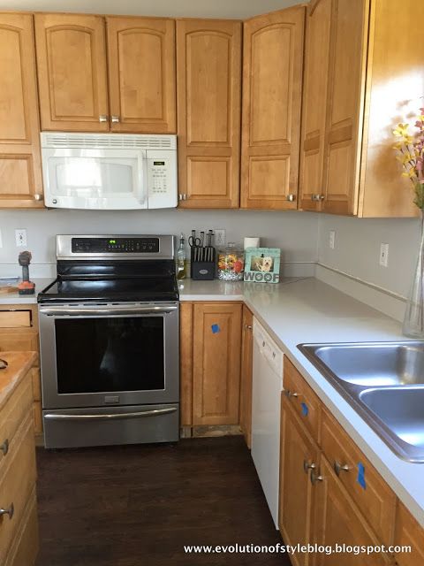 a kitchen with wooden cabinets and stainless steel appliances