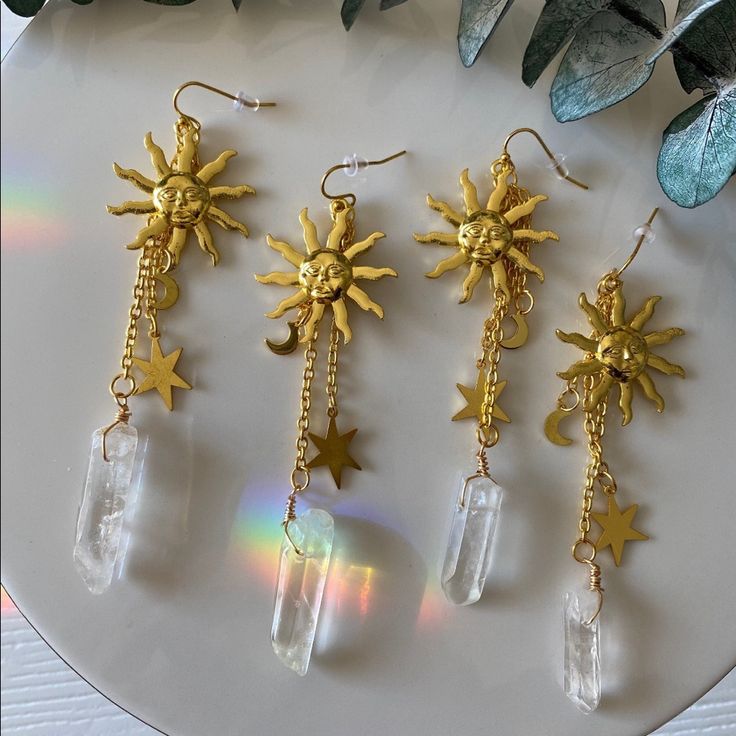 Celestial Babe, These Are For You! These Statement Earrings Will Brighten Up Any Room You Walk Into And Are Bound To Receive Tons Of Compliments! This Listing Is For One Pair Of Earrings Chosen At Random. Every Quartz Crystal Is Different And Unique. Size And Shape Will Vary Slightly. All Of Our Crystals Are Charged In Sunlight & During The Most Recent Full Moon. All Items Are Stored In A Dog Loving, Smoke Free Home! Gold Crystal Earrings With Dangling Charms As Gift, Mystical Gold Crystal Earrings Gift, Magical Gold Earrings As Gift, Magical Gold Earrings For Gift, Rainbow Stone, Gold Sun, Energy System, Witchy Vibes, Hanging Earrings