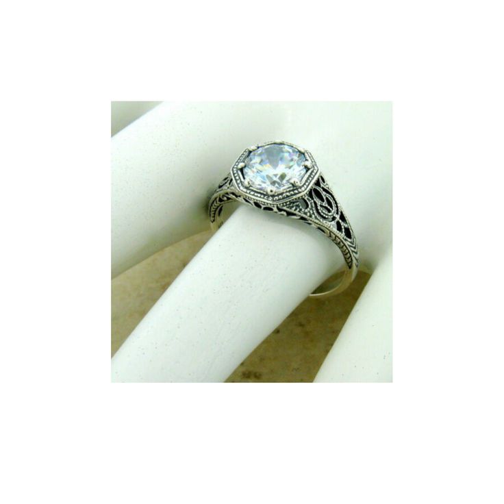 Vintage Estate Cubic Zirconia Solitaire Filigree Ring. 925 Solid Sterling Silver. Set With One 7 mm Round Faceted Cubic Zirconia Stone. Stamped 925. Excellent Condition/Like New. Diamond White Sterling Silver Birthstone Wedding Ring, Diamond White Sterling Silver Wedding Birthstone Ring, Diamond White Sterling Silver Birthstone Ring For Wedding, Wedding Birthstone Ring In Diamond White Sterling Silver, Dazzling Sterling Silver Topaz Ring For Anniversary, Wedding Sterling Silver Diamond White Birthstone Ring, Classic Silver Engraved Ring With Diamond Cut, Dazzling Sterling Silver Wedding Jewelry, Classic Silver Engraved Diamond Cut Ring