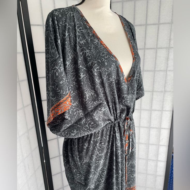 It Doesn’t Get Any Easier Than This One-And-Done Dress Caftan From Karma Highway. One Size Means It Fits Almost Everyone, Just Cinch The Waist Or Leave It Loose And Easy. With A Bandeau Or Tank Underneath, Or As A Classy Swimsuit Coverup, You Can Wear This Just About Anywhere. This Is A Beautiful Floral Pattern In Different Shades Of Gray With Orange Ands Cream Accents. Picture With Model Is Of Another Color Dress, Wearing A Bandeau Bra Underneath. Bra Top Available In Another Listing. Bohemian V-neck Kaftan With Tie Waist, Bohemian Kaftan With Tie Waist And Kimono Sleeves, Bohemian Orange Dresses With Kimono Sleeves, Bohemian Orange Wrap Kimono, Orange Long Sleeve Bohemian Kaftan, Orange Long Bohemian Cover-up, Long Orange Bohemian Cover-up, Classy Swimsuit, Different Shades Of Gray